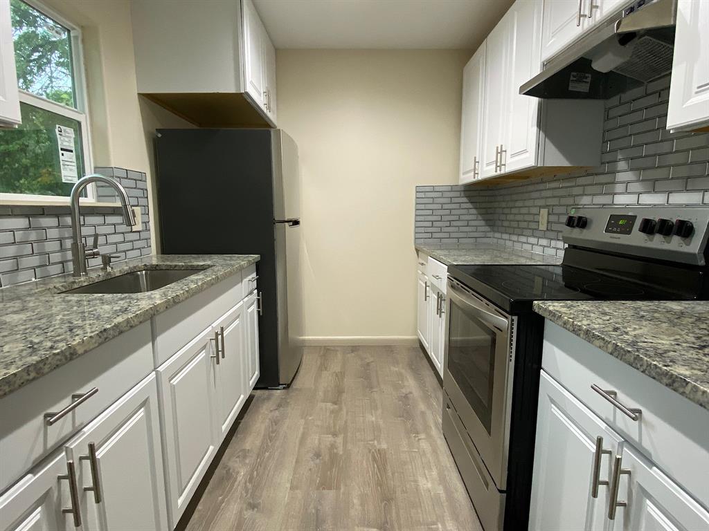 a kitchen with a stove and a refrigerator