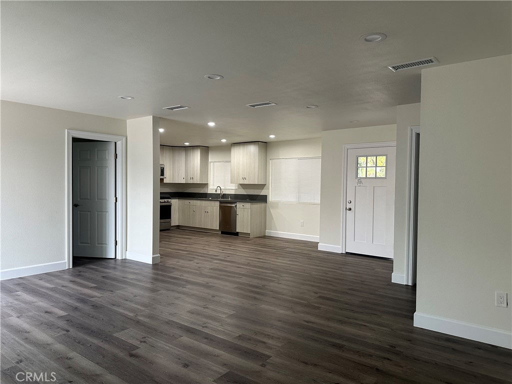 a view of kitchen with wooden floor and a refrigerator