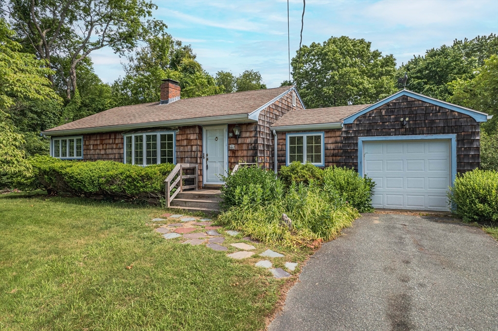 a front view of a house with garden