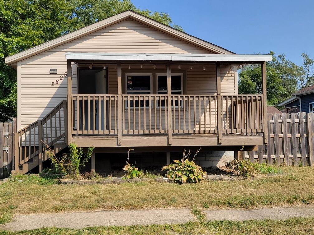 a front view of a house with a yard patio and furniture