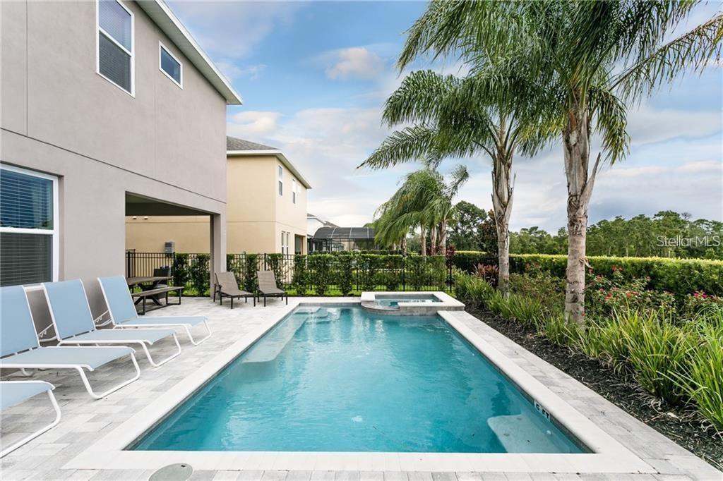 a view of swimming pool with chairs