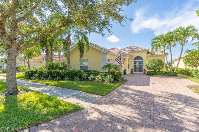 Mediterranean / spanish house featuring french doors and a front yard