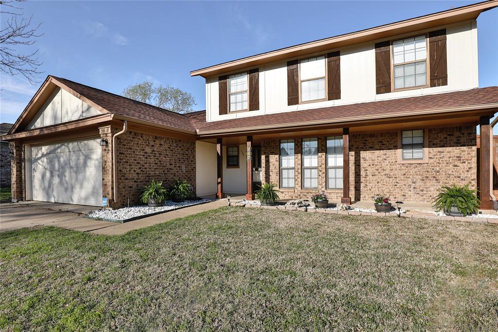 a front view of a house with a yard and seating space