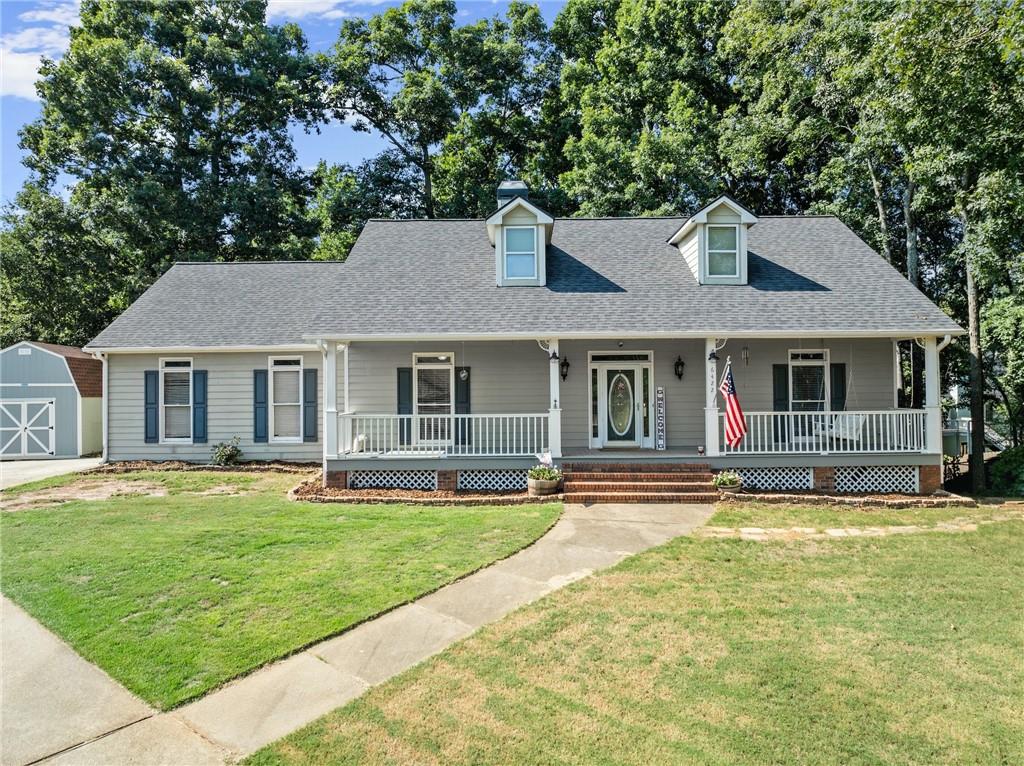 a front view of a house with a garden and patio