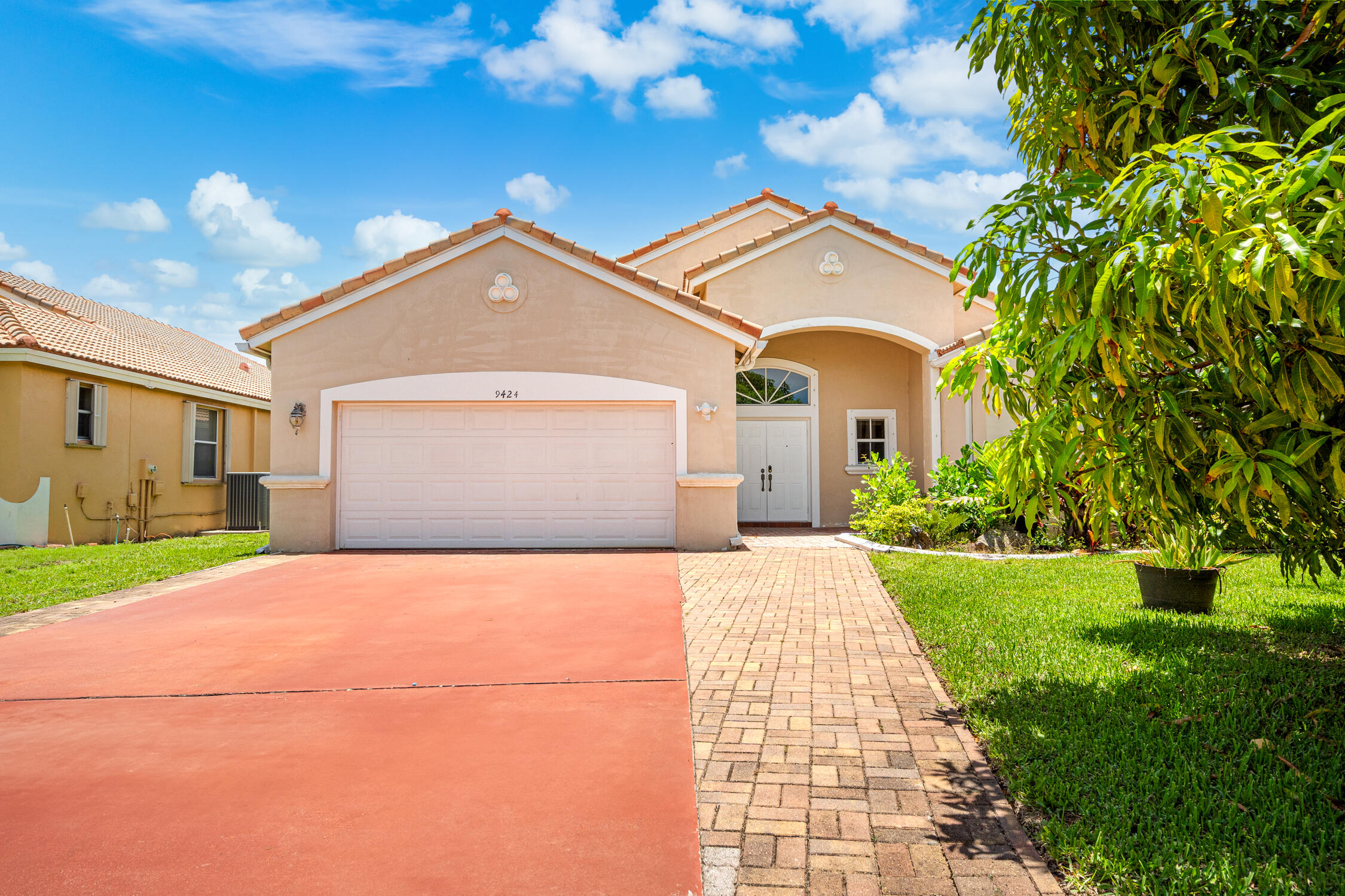 a front view of a house with a yard and garage