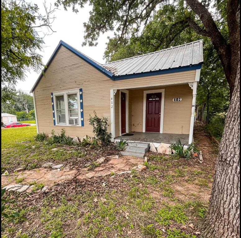 a view of a house with yard and a garden