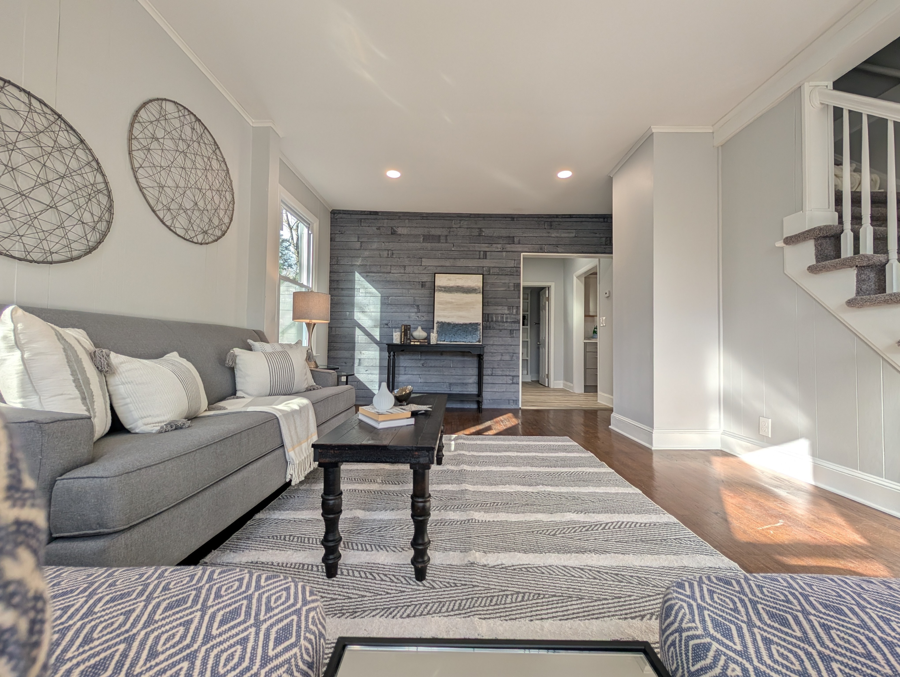 a living room with furniture and a clock