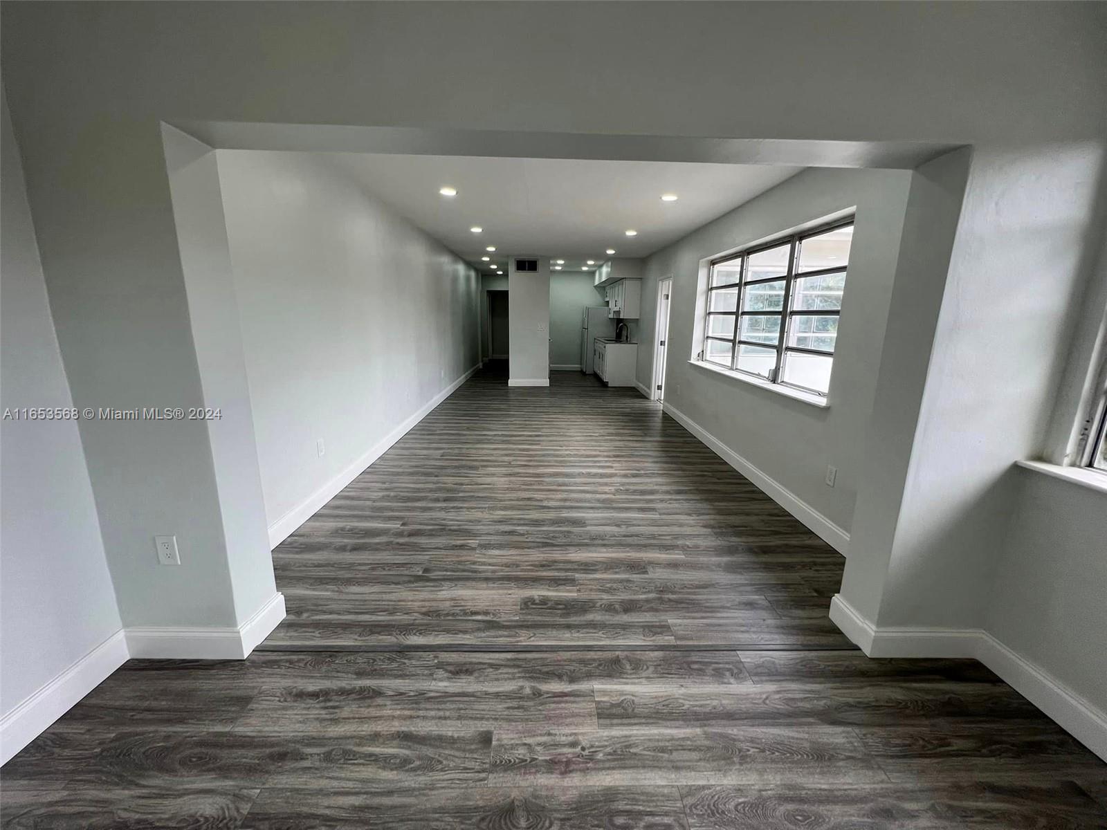 a view of gallery with wooden floor