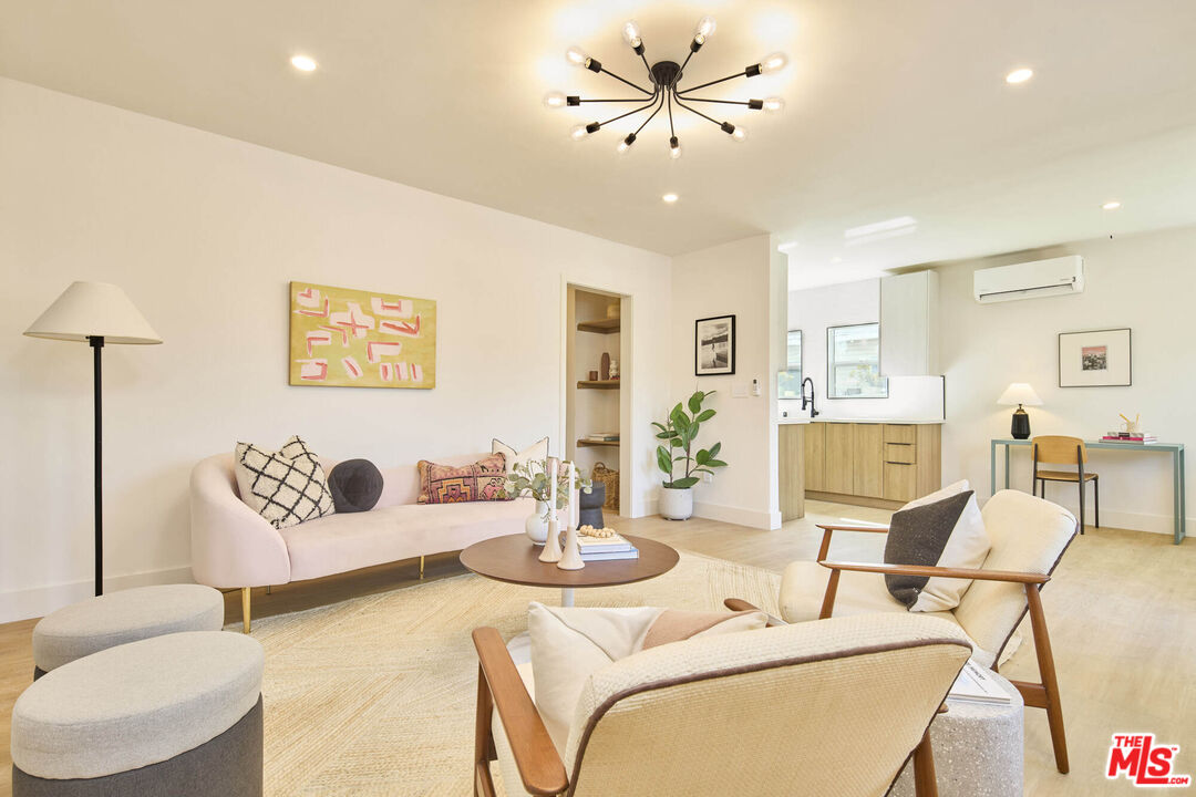 a living room with furniture and a chandelier