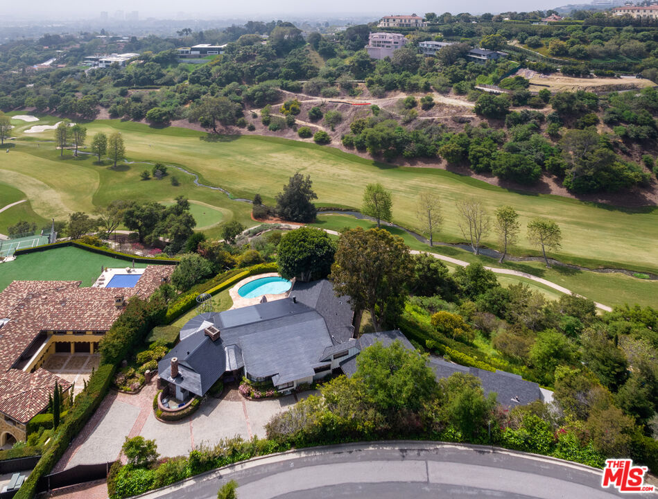 an aerial view of residential houses with outdoor space and lake view