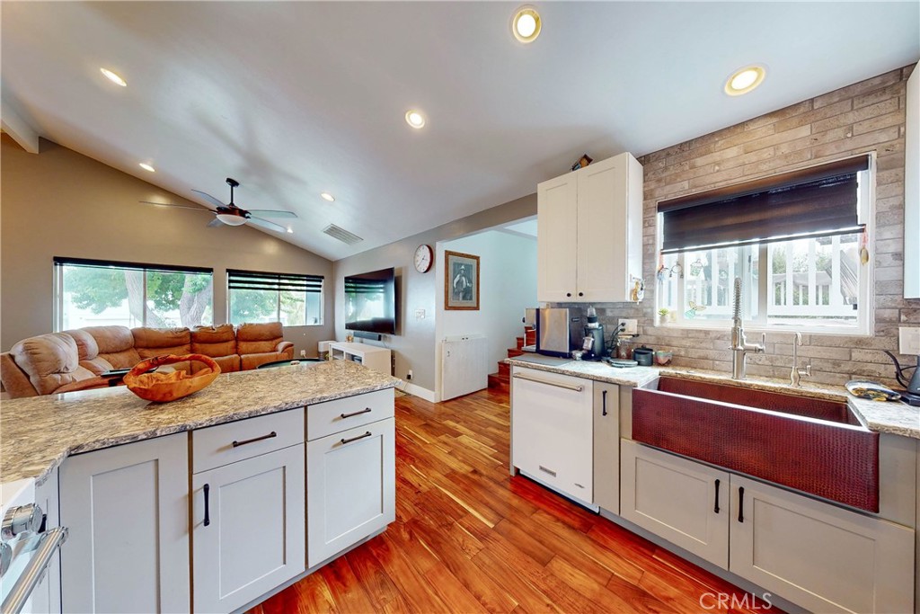 a kitchen with stainless steel appliances granite countertop a sink and cabinets