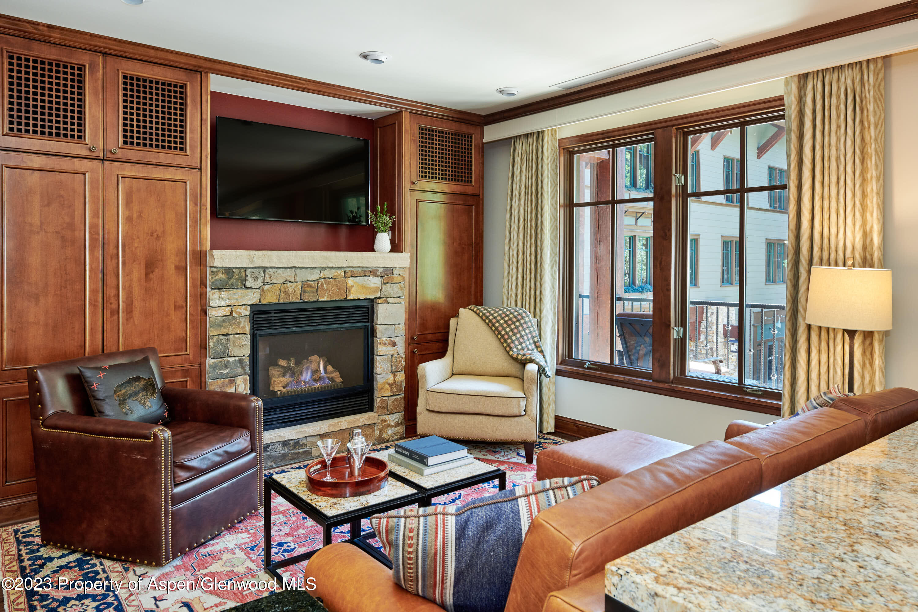 a living room with furniture fireplace and flat screen tv