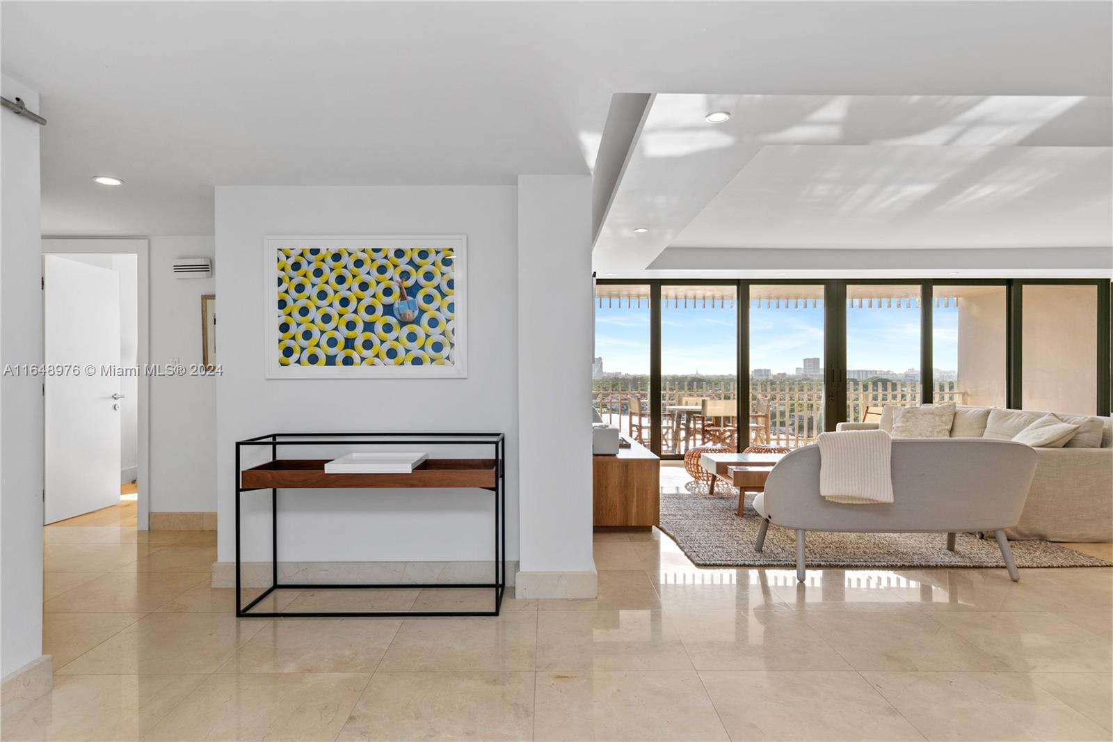 a living room with furniture and a floor to ceiling window