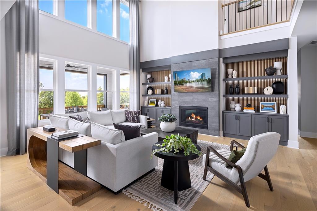 a living room with furniture a fireplace and a large window