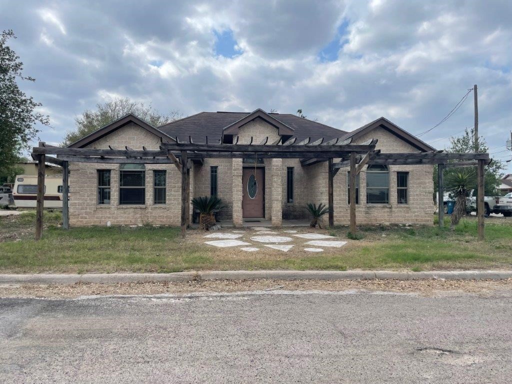 a front view of a house with a garden