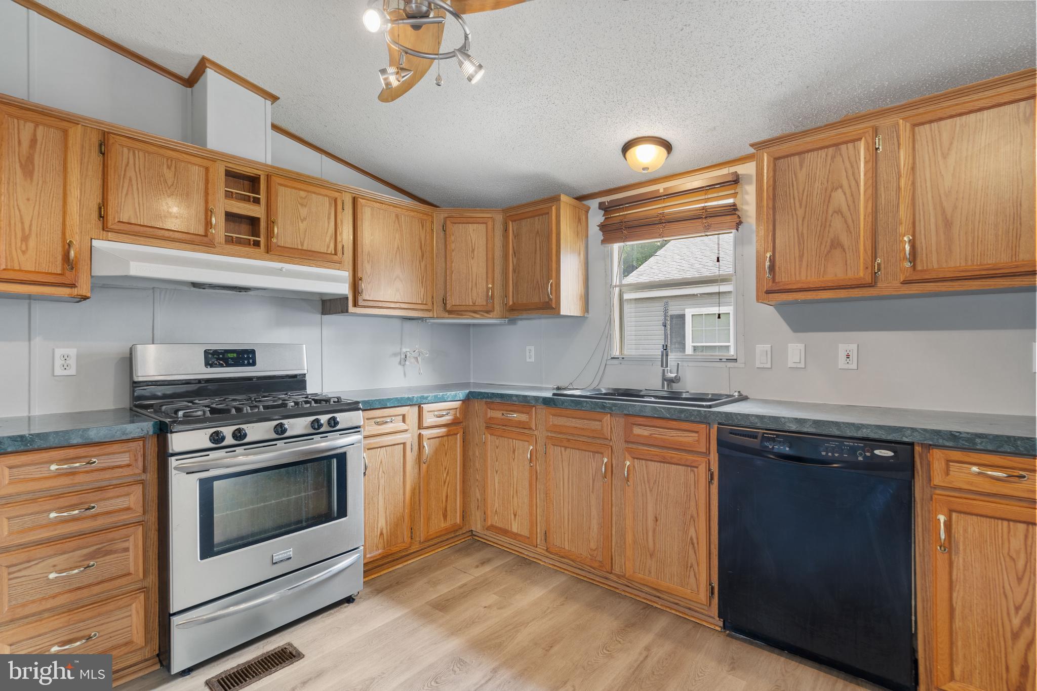 a kitchen with stainless steel appliances granite countertop a stove and a sink