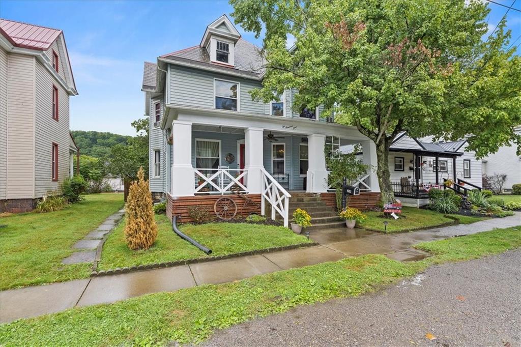 a front view of a house with a yard table and chairs