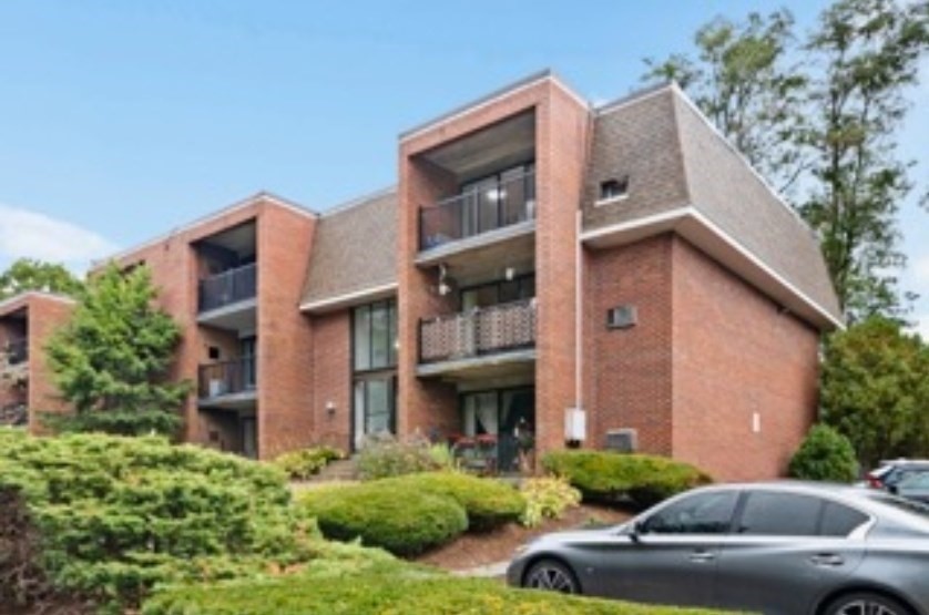 a view of a car park in front of a house