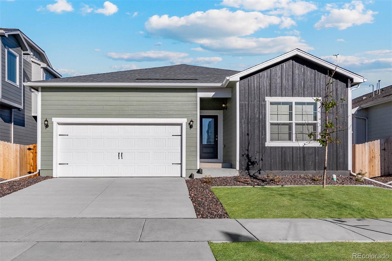 a front view of a house with a yard and garage