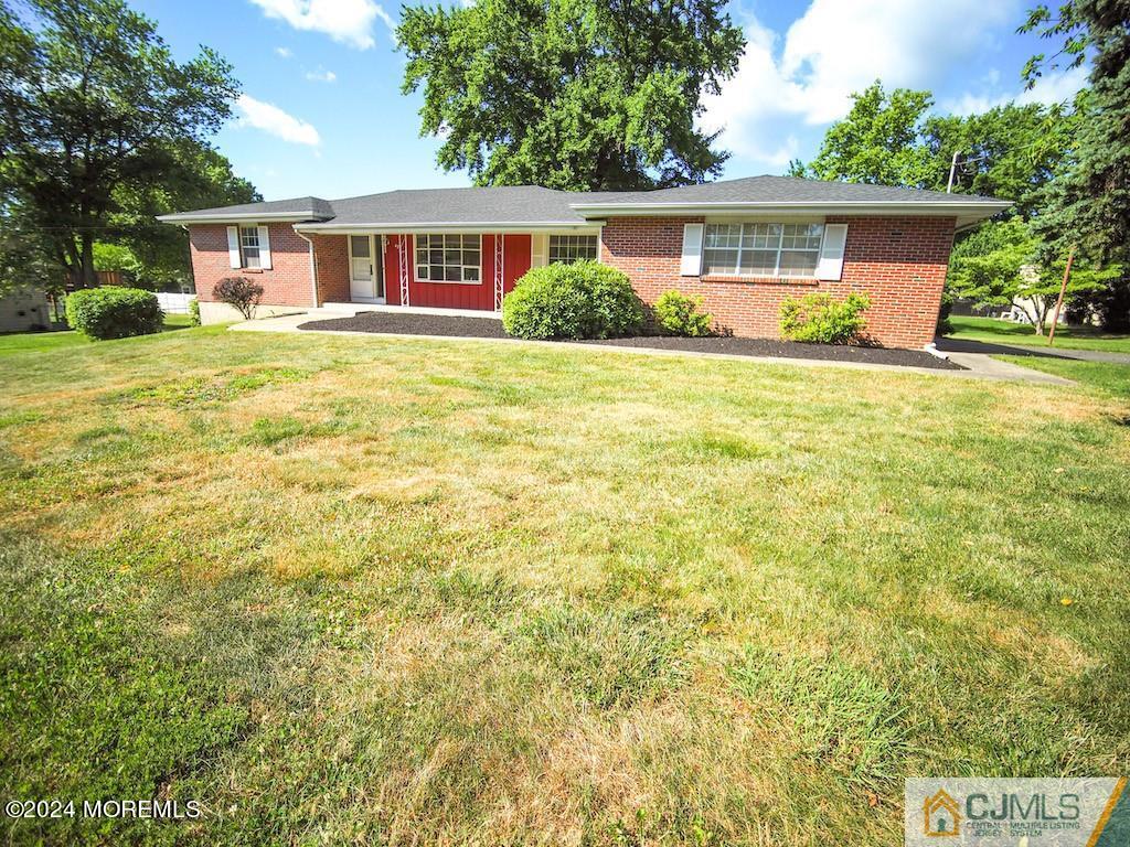 a front view of house with yard and green space