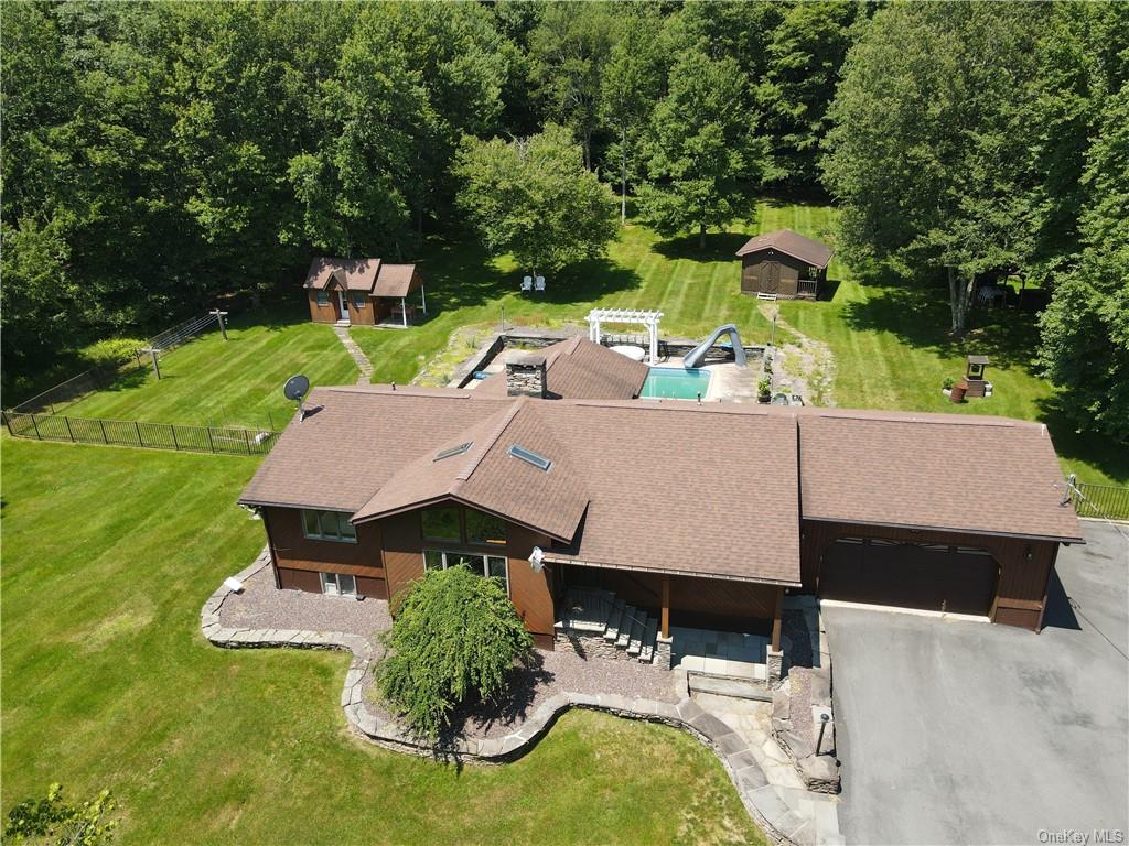 an aerial view of a house with swimming pool garden and patio