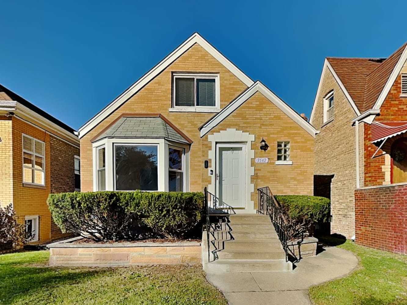 a front view of a house with a yard