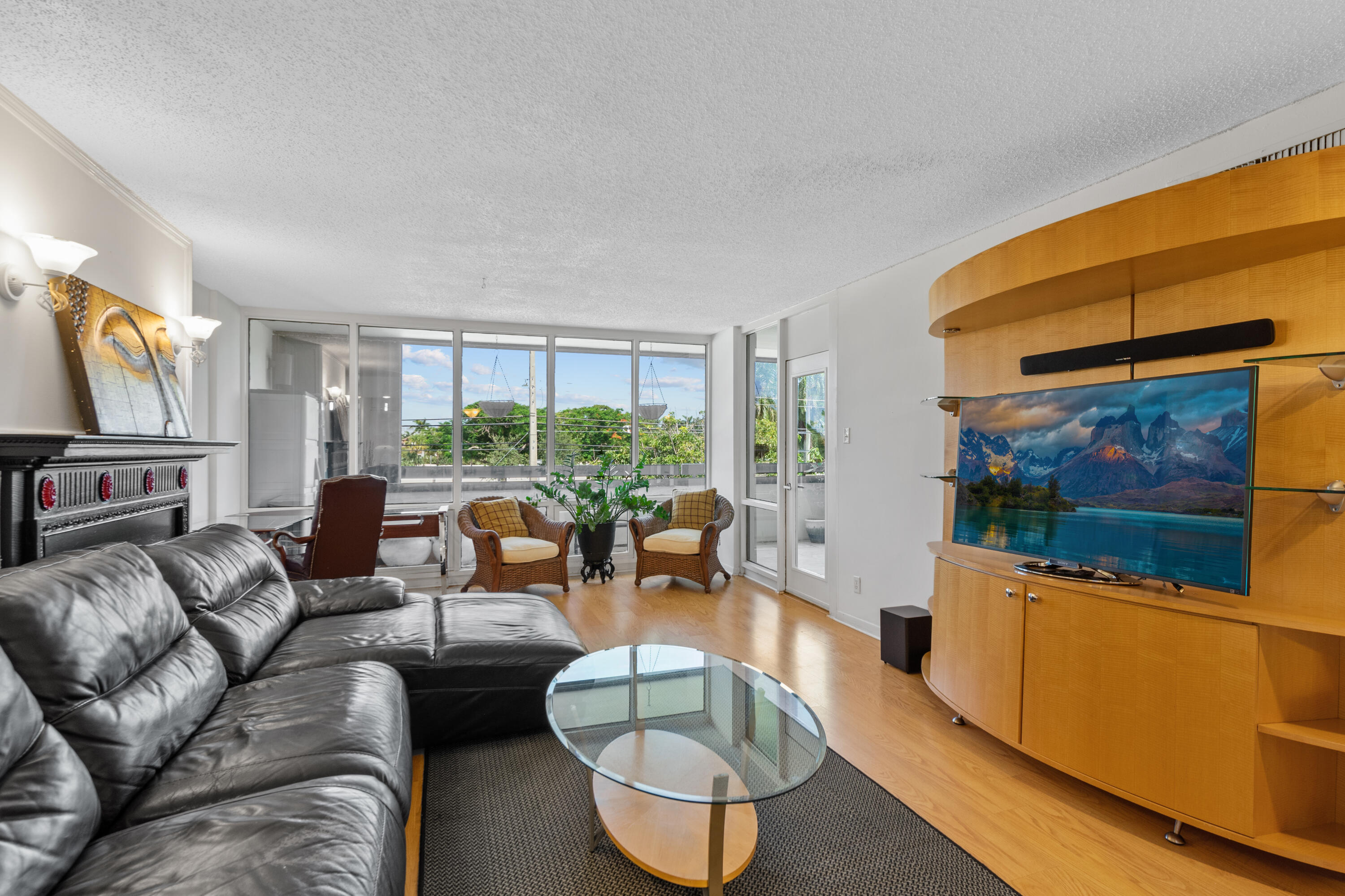 a living room with furniture a large window and a flat screen tv