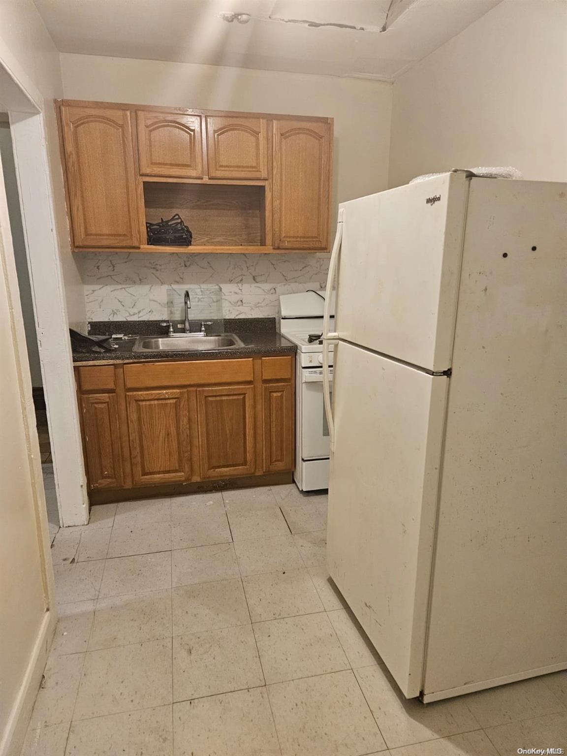 a white refrigerator freezer sitting in a kitchen