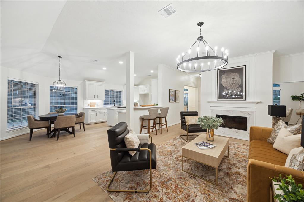 a living room with furniture chandelier and a table