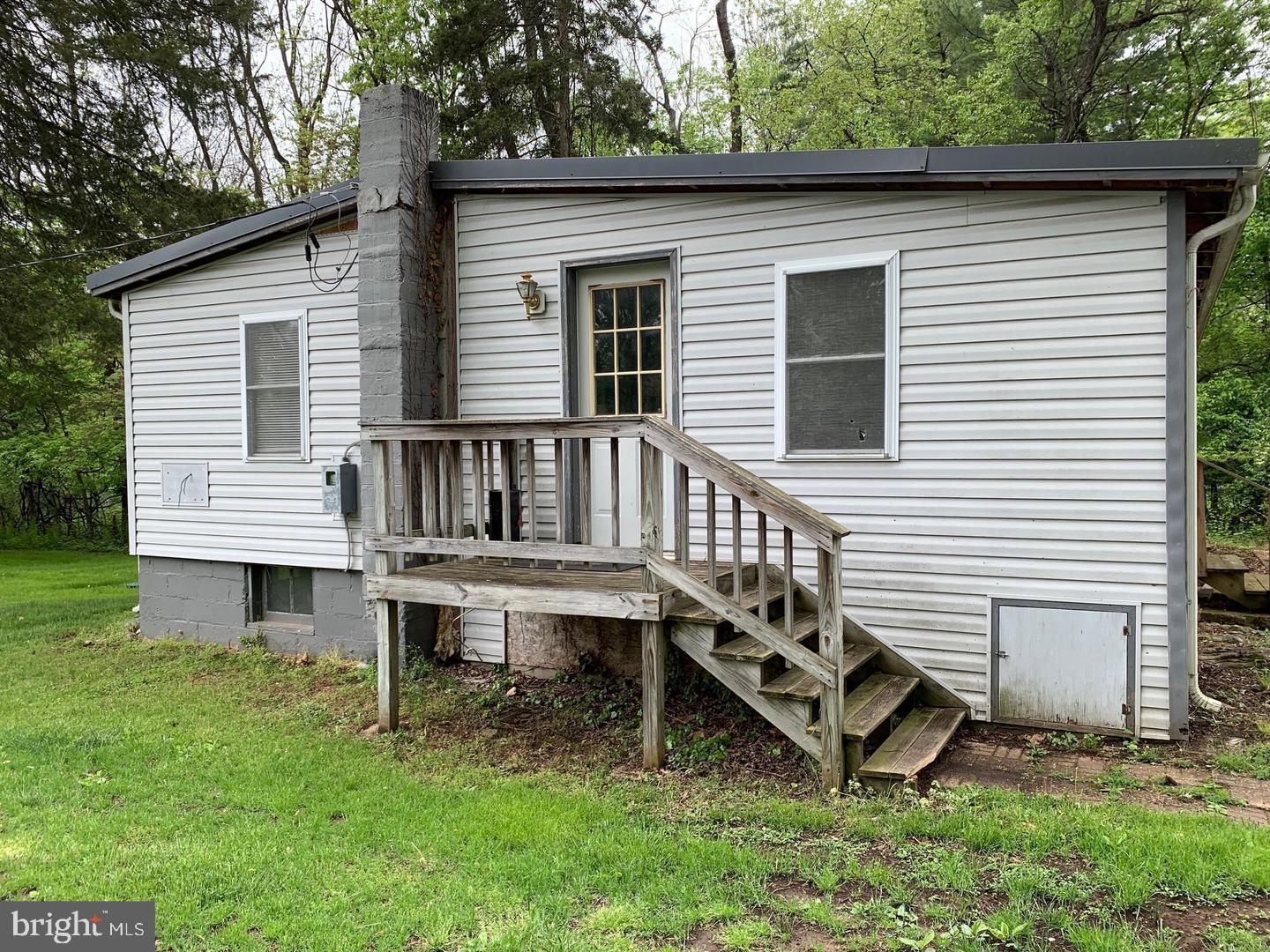 a view of a house with a yard and sitting area