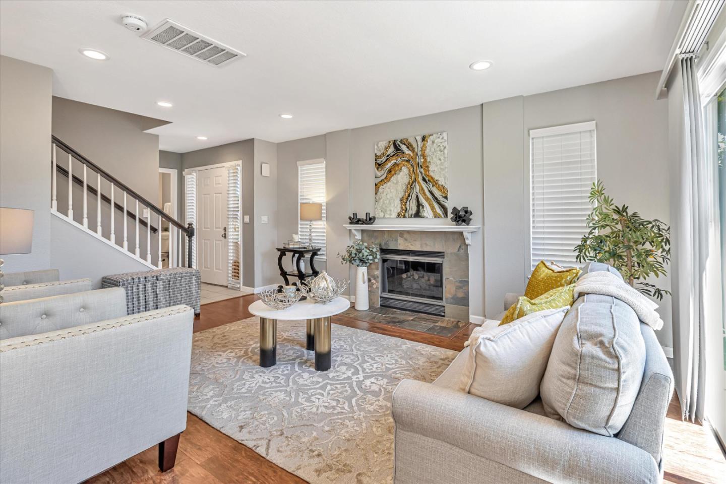 a living room with furniture and a fireplace