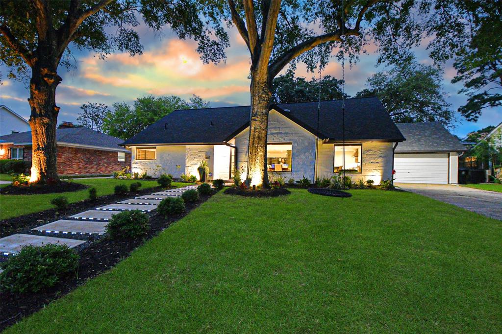 a front view of a house with a garden