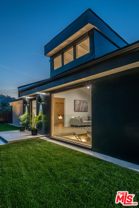 a view of a house with a yard and sitting area