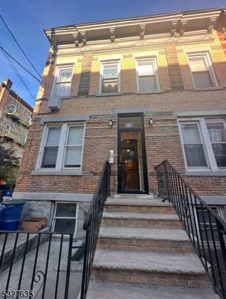 a view of a brick house with a large door