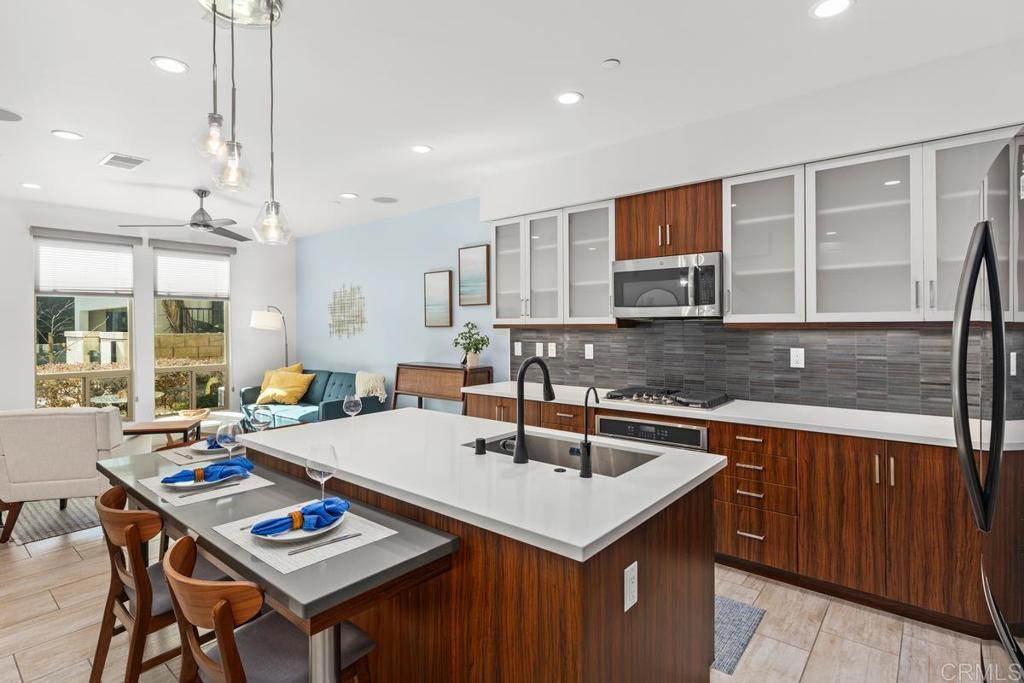 a kitchen with a sink a counter top space and appliances