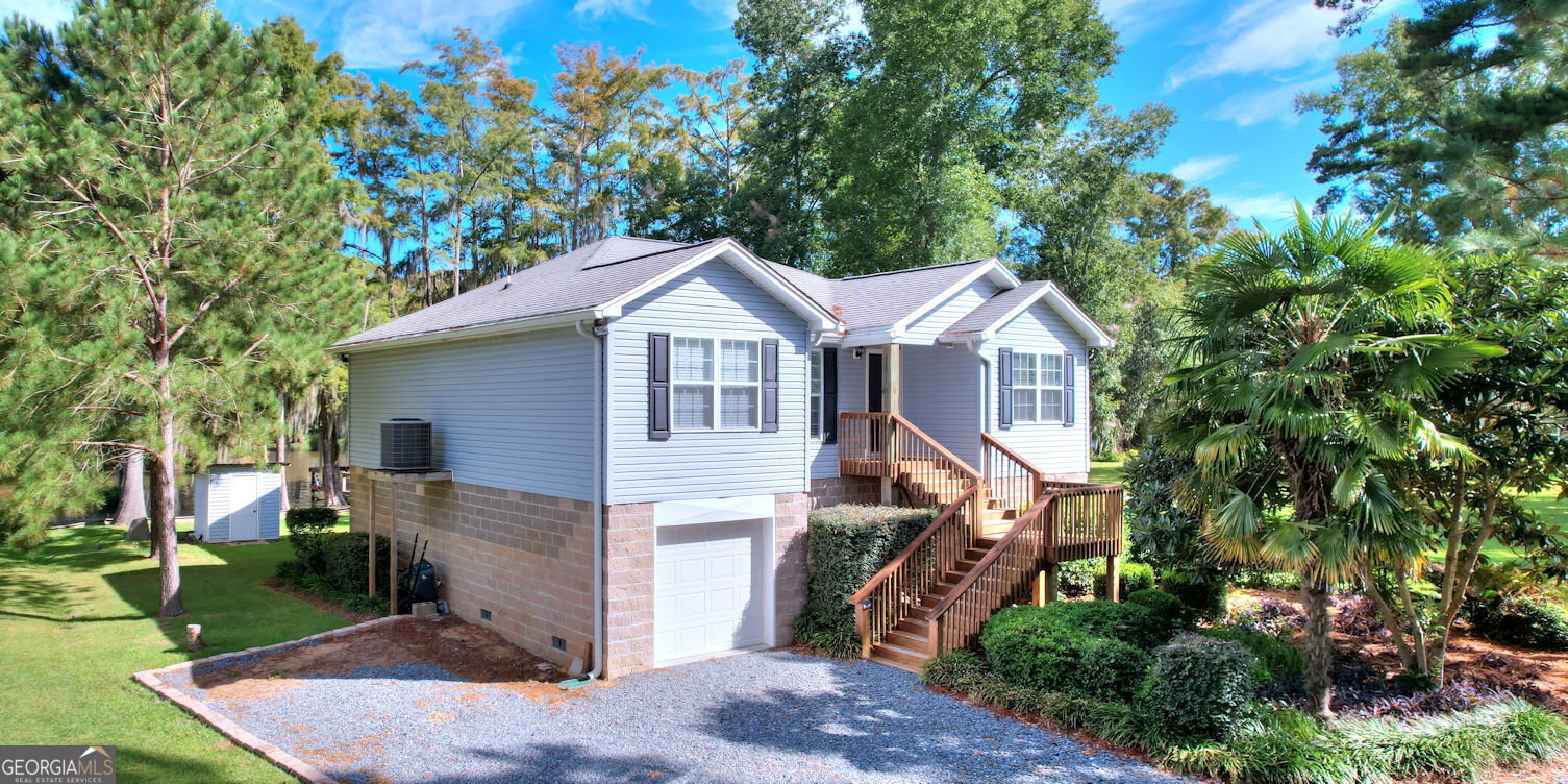 a front view of a house with a yard and trees