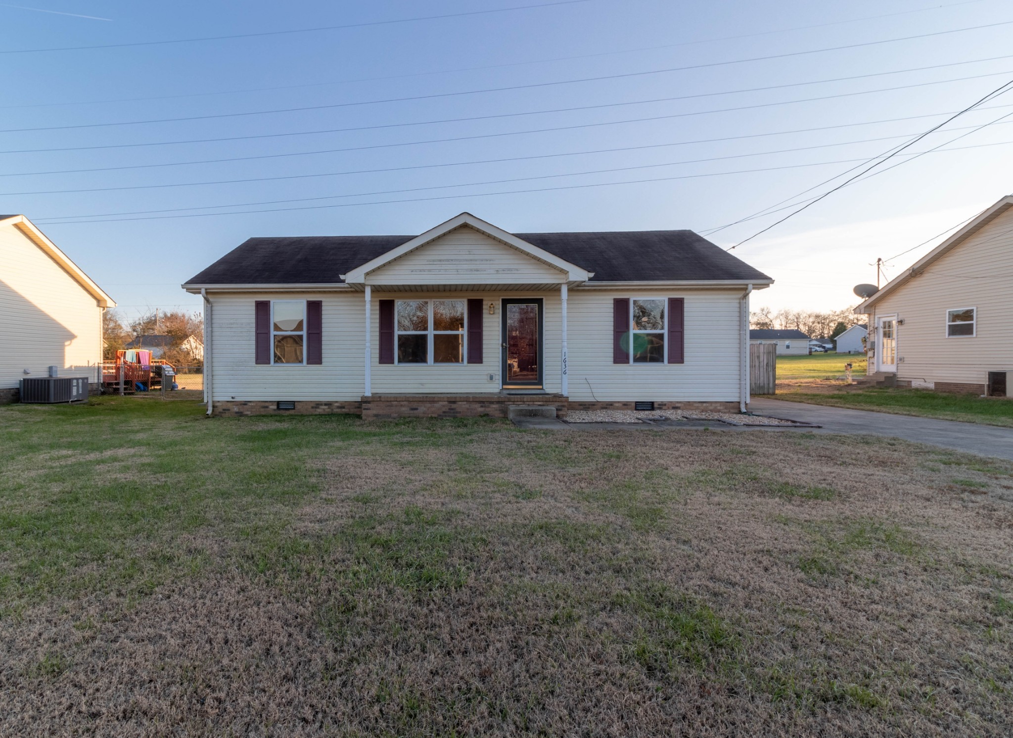 a front view of a house with a garden and yard