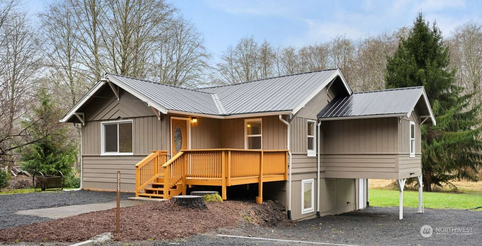 a view of a house with a yard and wooden fence