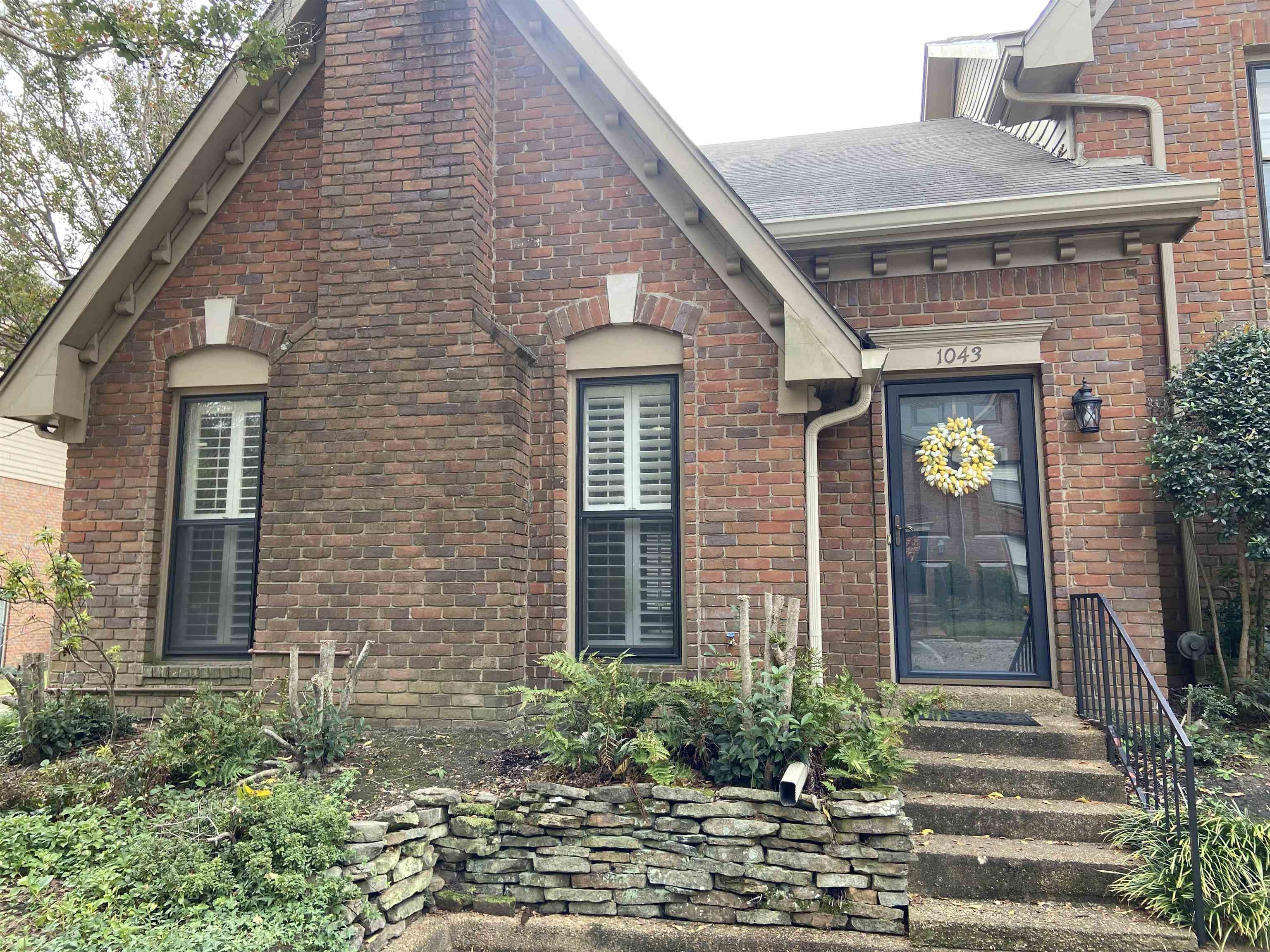 a front view of a house with a garden