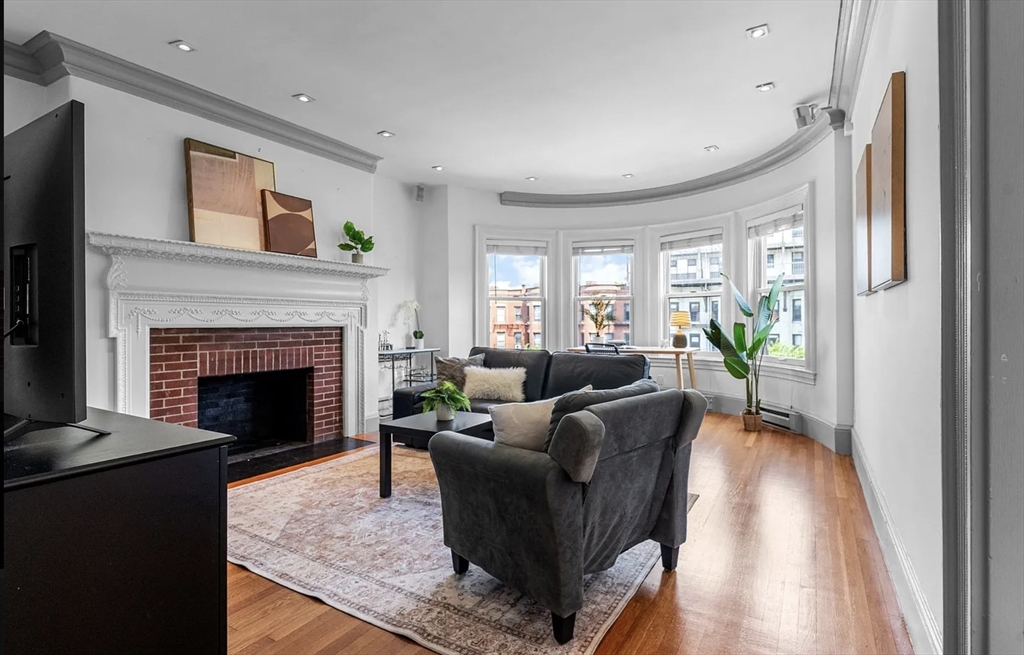 a living room with furniture and a fireplace