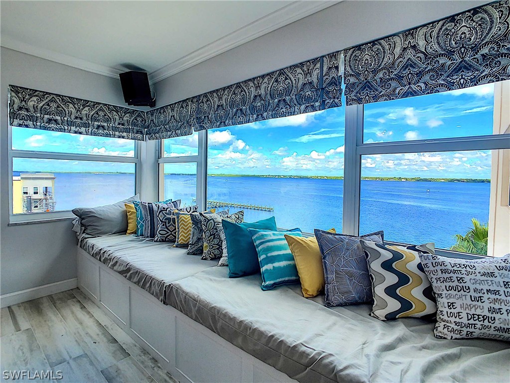 a large living room with furniture and floor to ceiling windows