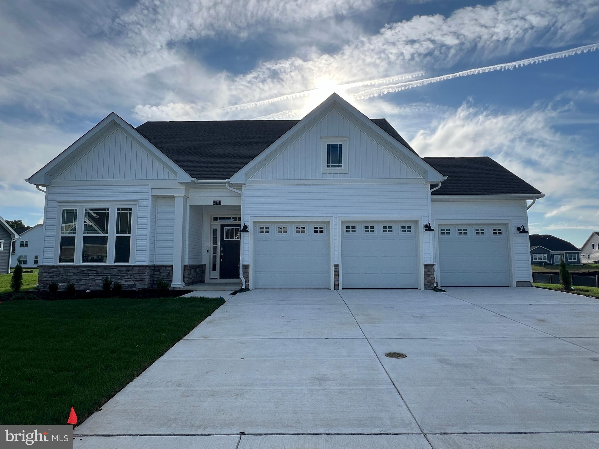 a view of a house with a yard and garage