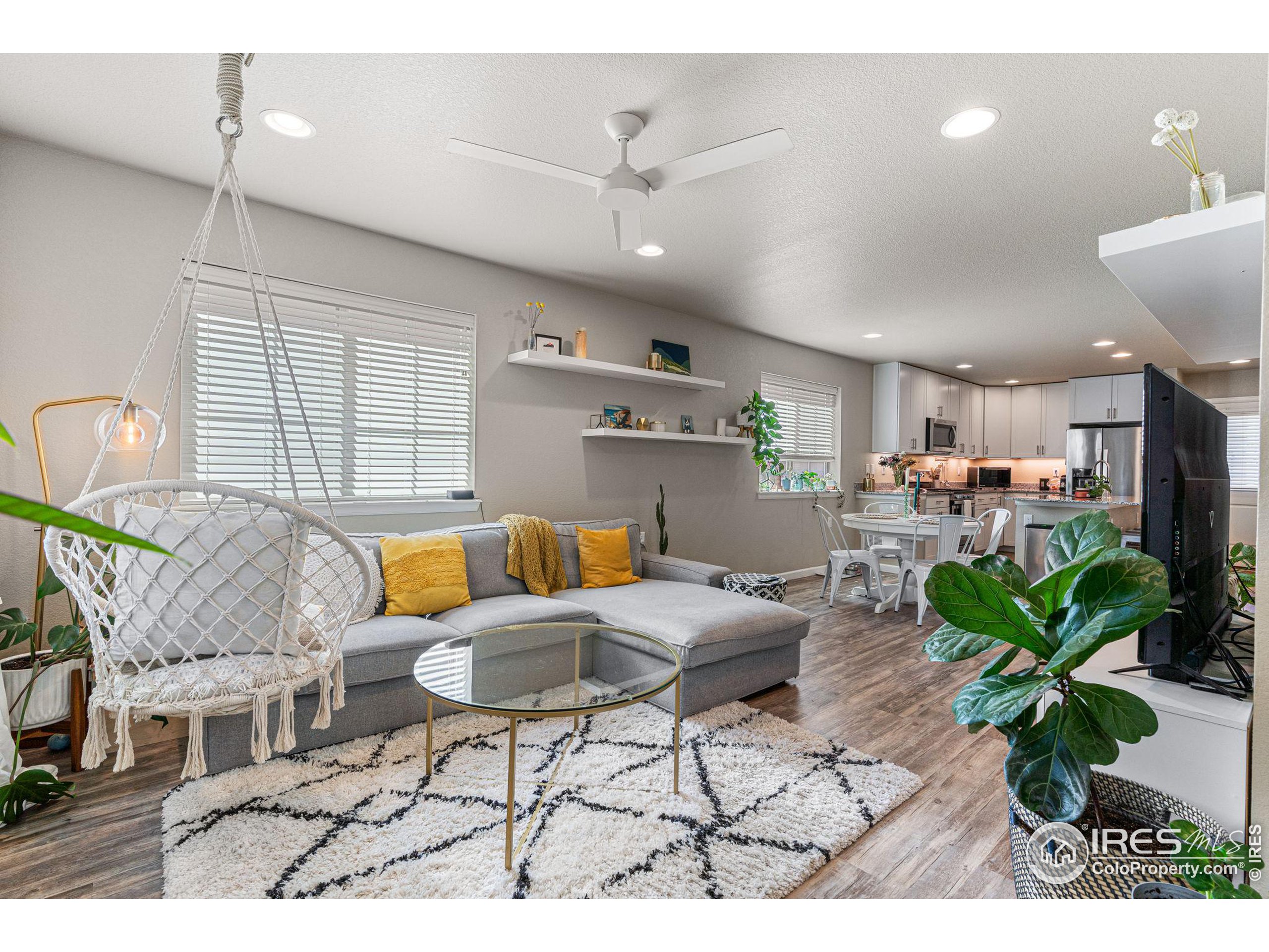 a living room with furniture and a potted plant