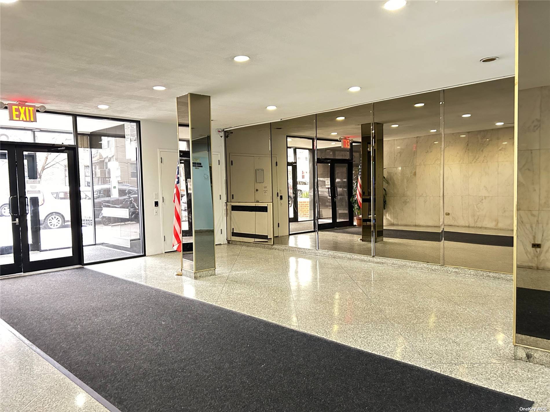 a view of a hall with a floor to ceiling window and stainless steel appliances