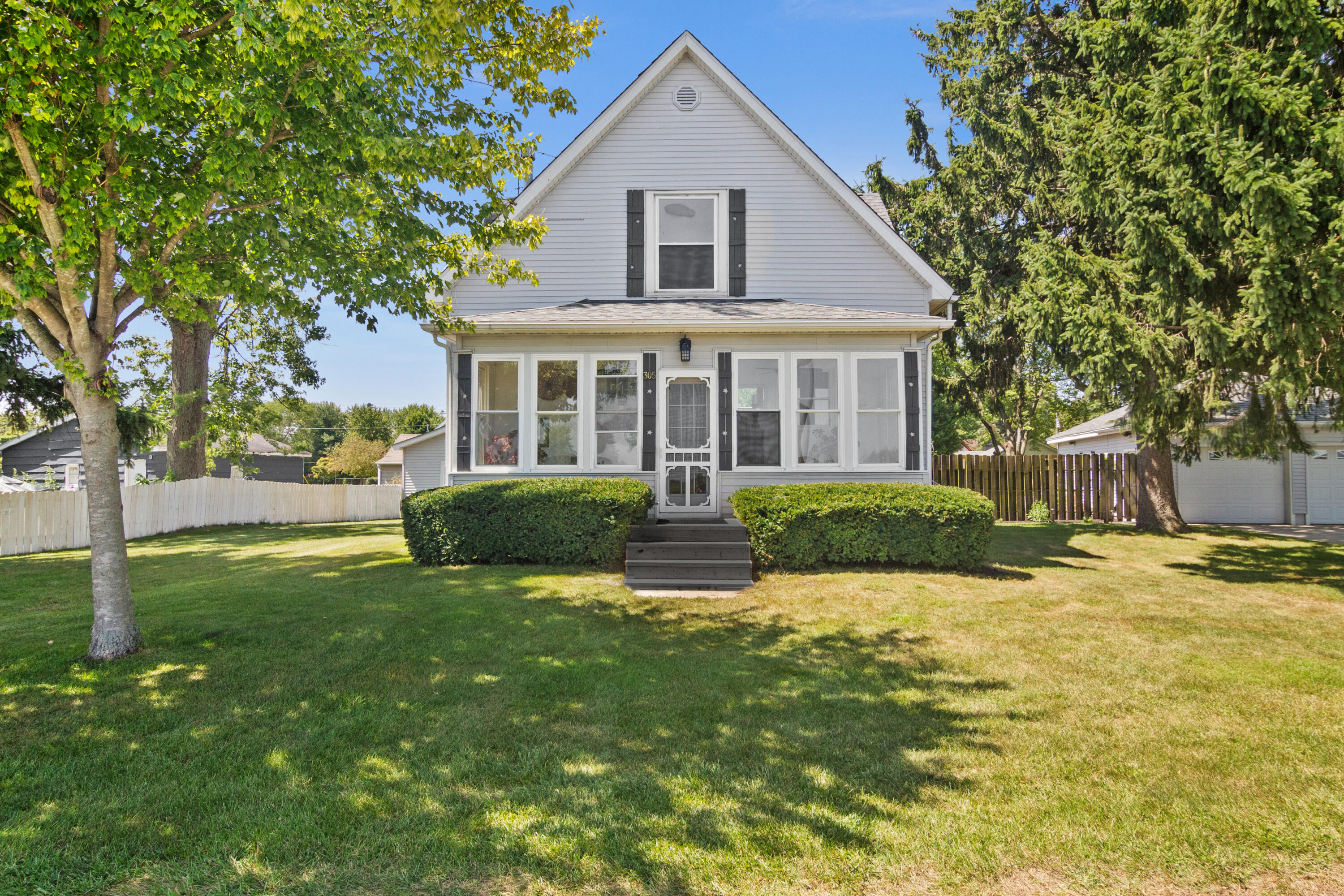 a front view of house with yard and green space