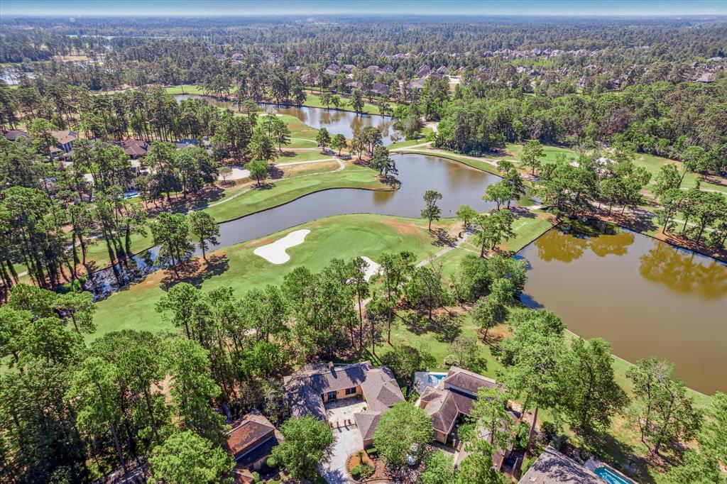 an aerial view of lake residential house with swimming pool and green space