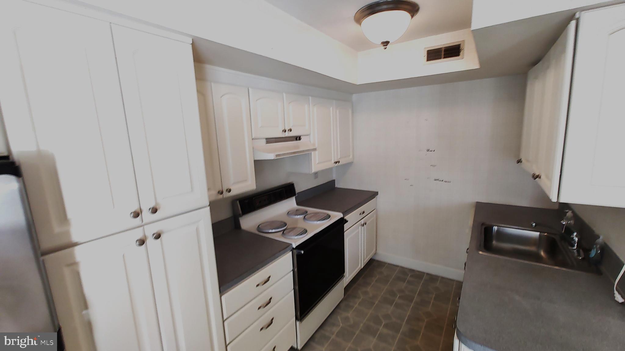 a kitchen with stainless steel appliances granite countertop a stove and a refrigerator