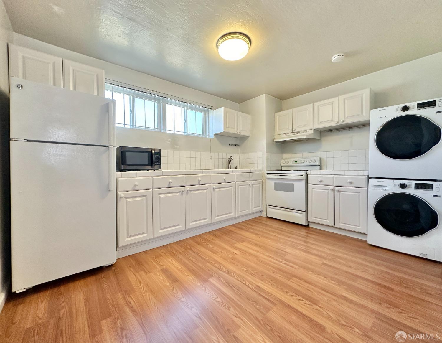 a kitchen with a sink a stove and cabinets