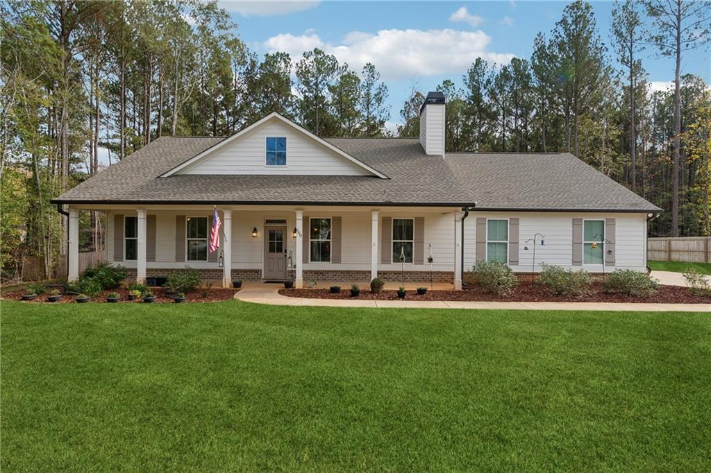 a front view of a house with a yard and trees