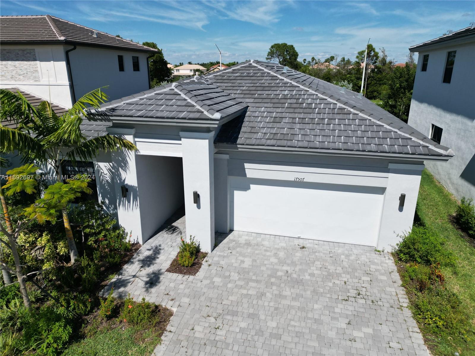 a front view of a house with a yard and garage